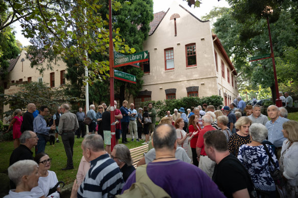 Residents gather outside the council’s chambers on Miller Street.