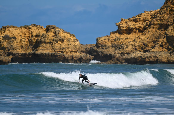 A surfer takes to the waves at Torquay. 