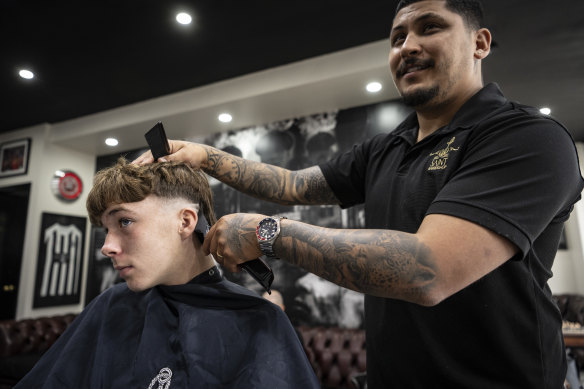Luca Vincent gets a trim from Saint Barbershop’s owner Andres Munoz in Coogee.