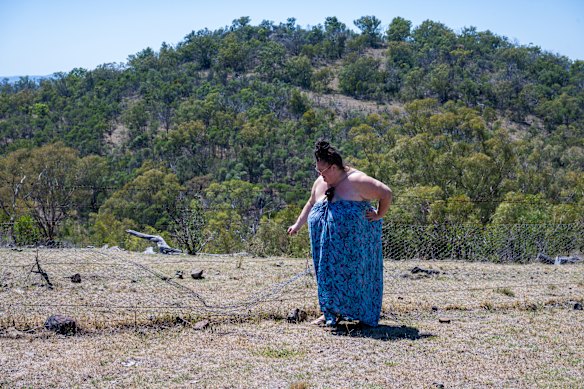 Kathy Pope on her Allawah farm alongside one of the damaged boundary fences.