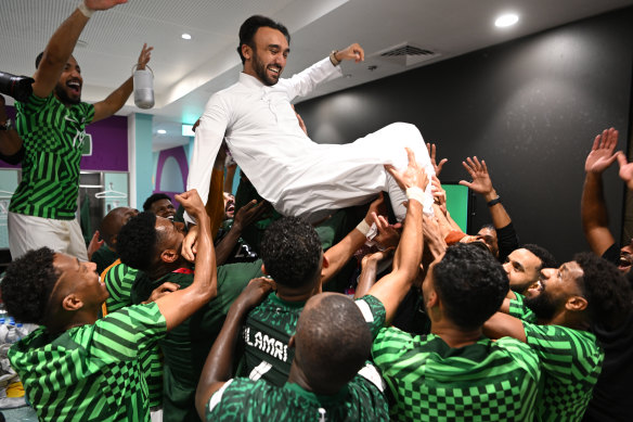 Saudi sports minister Prince Abdulaziz bin Turki Al-Faisal celebrates with the national team following their shock win over Argentina at the World Cup.