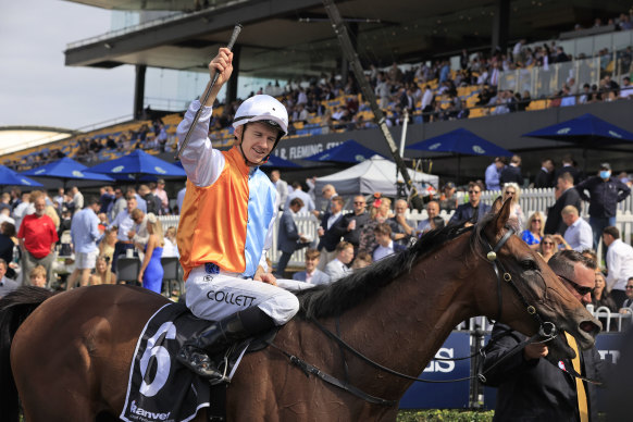 Jason Collett salutes the Rosehill crows as he returns to scale after his victory on Montefilia in the Ranvet Stakes.