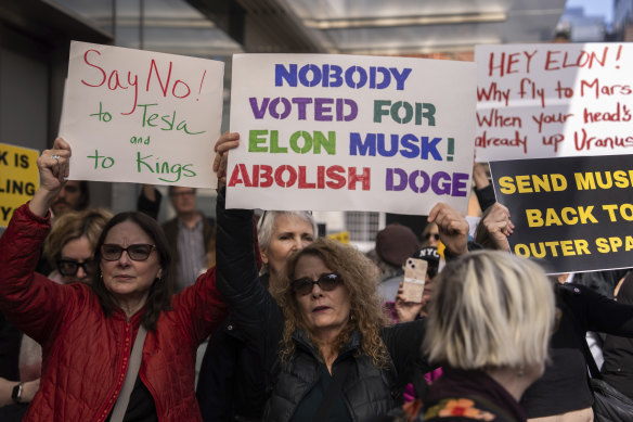 Demonstrators take part in a protest against Elon Musk and Tesla outside of a Tesla showroom in New York.