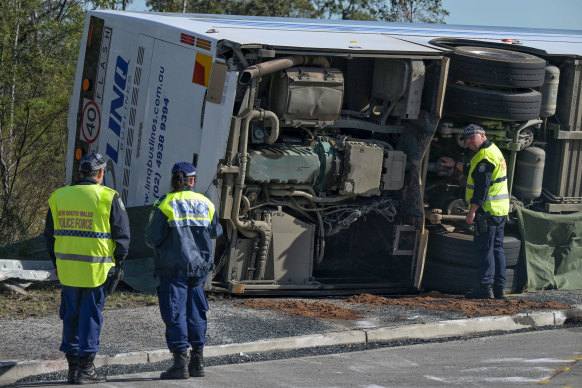 The bus slammed into a guard rail and rolled onto its side.