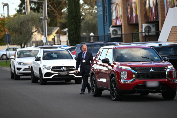 Oakleigh Grammar School deputy principal Peter Dickinson walks among congested traffic at pick-up time.