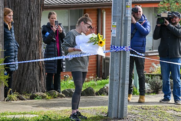 Friend Elisha Brown drops flowers off at the scene.
