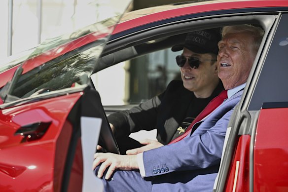 Musk and Trump show off a Tesla at the White House in March.