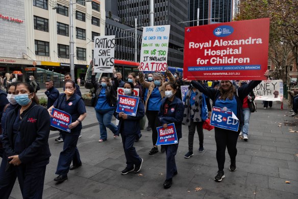 Unionised nurses and midwives arrive at Sydney Town Hall for their meeting on Tuesday.