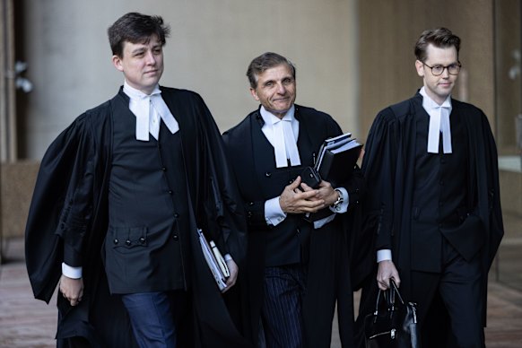 Roberts-Smith’s barrister Arthur Moses, SC (centre), and colleagues arrive at the Federal Court in Sydney on Friday.