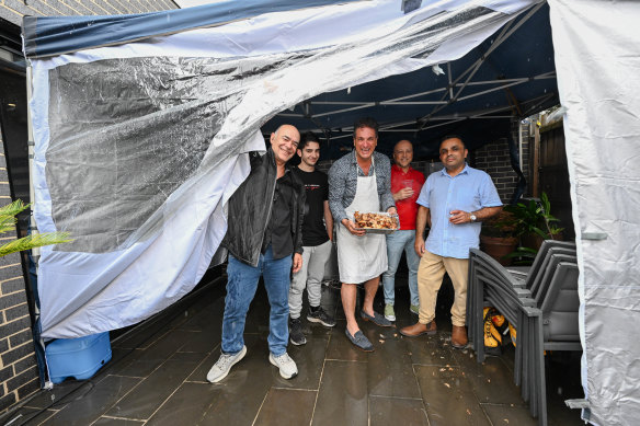 Jim and Surita Zags host Christmas at their house, using a marquee to protect their cooking area from the rain.