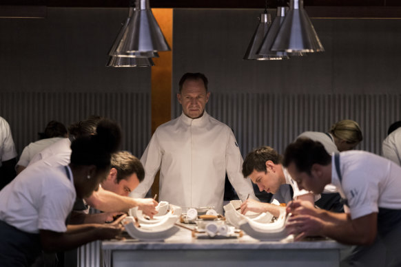 Ralph Fiennes plays Julian Slowik, a chef at a high-end restaurant who is basically a cult leader, in the horror-tinged The Menu. 