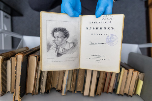 A university employee presents a fake copy of a first edition of the 1822 book ‘Kavkazskiy plennik: povest’ by Alexander Pushkin at the University of Warsaw library in Poland.