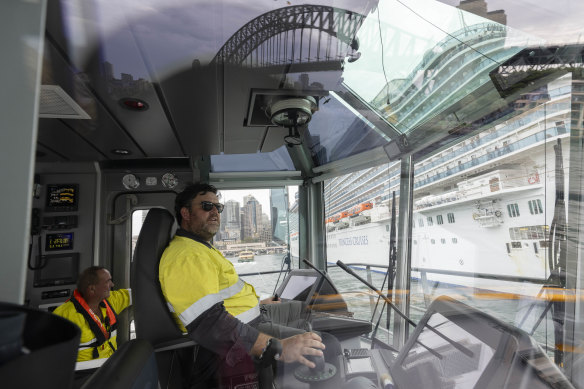 Tug master Dom McCarron with deckhand Dave Barringer on the Engage Rascal tug in Sydney Harbour.