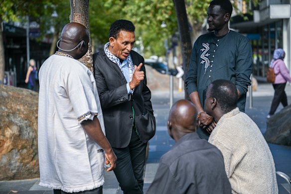 Dr Berhan Ahmed talks to community members at the Nicholson Street Mall in Footscray on Thursday. 
