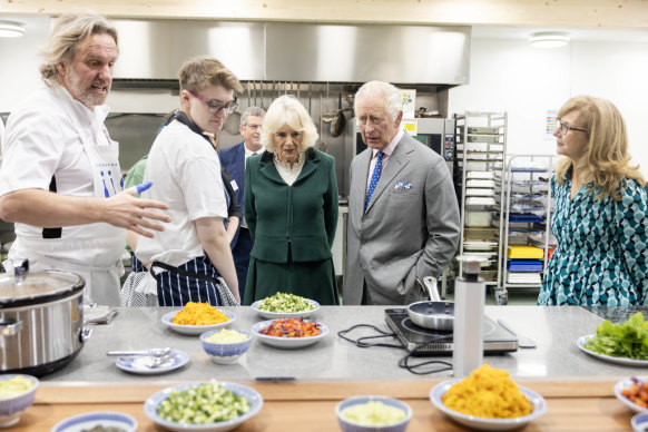 Queen Camilla and King Charles on an official visit at a food distribution centre in England.