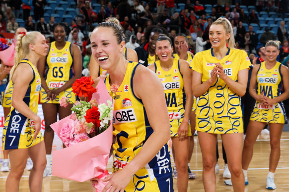 Swifts star Paige Hadley smiles after being presented with flowers by her niece after playing her 150th match.