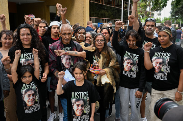 Veronica Nelson’s partner Percy Lovett (second from left) and her mother Donna Nelson (centre) with family and supporters in January.