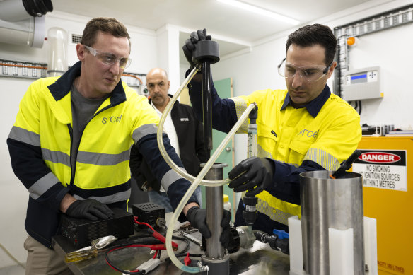 Sircel chief executive Anthony Karam (centre) looks on while metallurgists Adam Roper and David Bension extract copper.