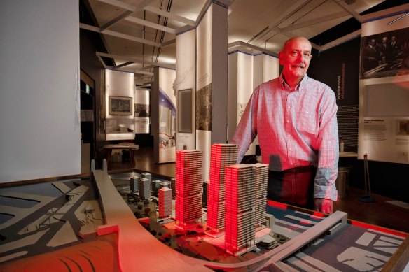 Professor Rob Freestone, the guest curator of a new exhibition at the Museum of  Sydney, stands in front of a model of a proposal that would have razed all of the Rocks. It didn’t go ahead because the company that won the tender couldn’t afford to buy  all the properties needed for redevelopment. 