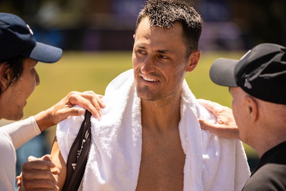 Bernard Tomic stops to speak with fans after his loss.