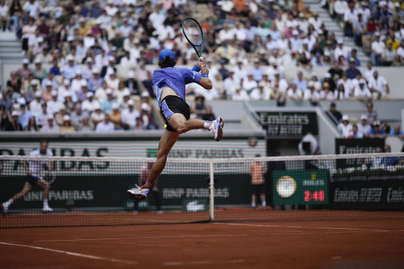 Alex De Minaur plays a shot against Daniil Medvedev.