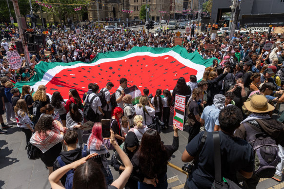 Protesters hold a watermelon flag in Melbourne at the School Strike for Palestine rally on November 23. Watermelons, which have the same the colours as the Palestinian flag, are used as symbols of Palestinian resistance.