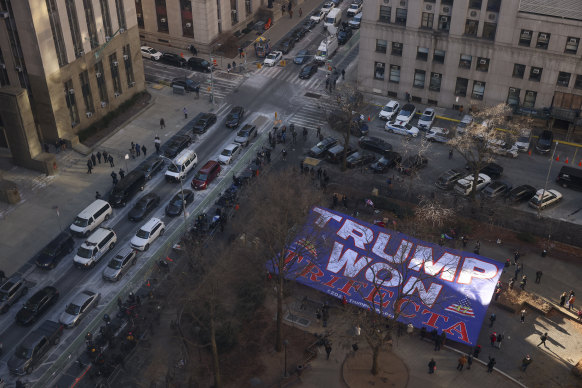 Supporters for President-elect Donald Trump display a banner outside Manhattan criminal court during the sentencing hearing.