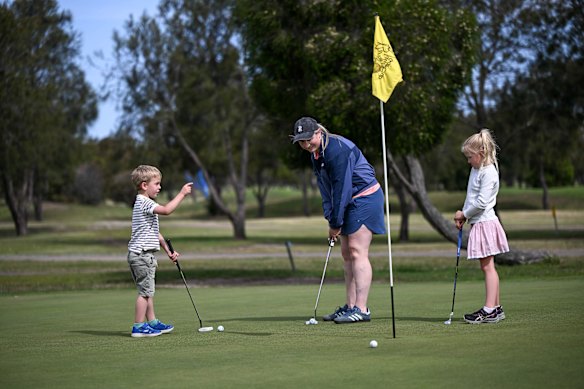 Paige Chrzanowski and her two children Evie (7) and Julian (5) play golf at Barwon Valley Golf Course.