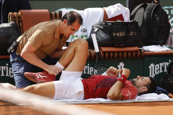 Novak Djokovic receiving medical assistance for his right knee during his fourth round match at Roland-Garros, which he won before withdrawing from his quarter-final.