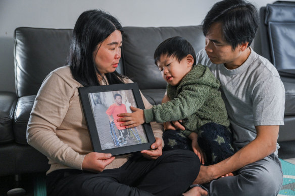 Lily Lumintang, her husband Martin Cahyo and their son Rafael, 3, with a photo of their other son Jonathan, 13.