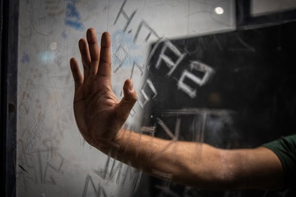 A prisoner waits in a cell for an imminent court hearing. 