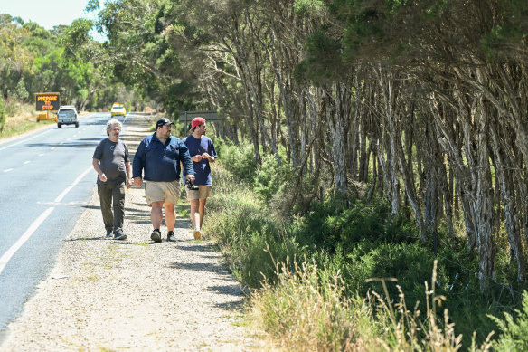 Adrian Marshall (left), Jordan Crook and Blake Nisbet, of the Victorian National Parks Association, walk along the perimeter of the proposed housing site in Dromana, which is home to the endangered swamp skink.