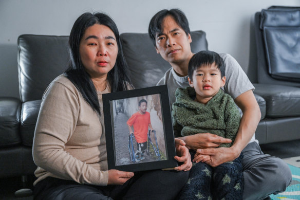 Melbourne professional Lily Lumintang (left) holds a picture of her disabled son, Jonathan, who is with family in Indonesia.