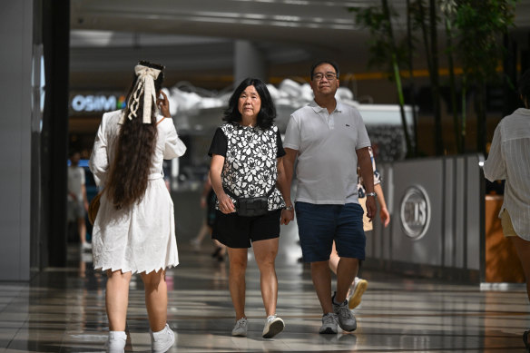 Bright Moon (centre) and Leong Goh walk around Chadstone for their exercise.