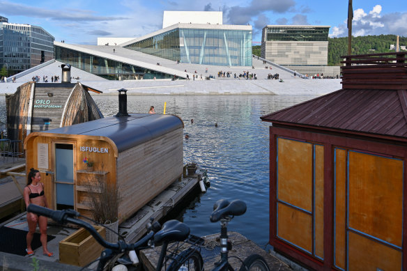 Saunas cling to the foreshore facing Oslo’s Opera House and the Munch Museum to its right. 