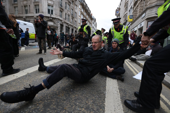 Extinction Rebellion activists are removed by City of London Police after they blocked the road during the Lord Mayor’s Show 2021 in London.