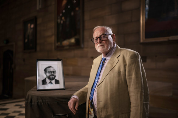 Ross Gittins in the Great Hall of Sydney University, with a portrait of himself taken in 1982.