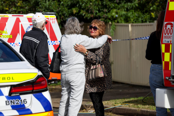 Neighbours comfort each other following the explosion.