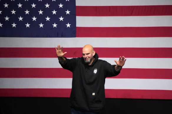 Senate seat flipped, Democrat John Fetterman waves to supporters at an election night party in Pittsburgh.