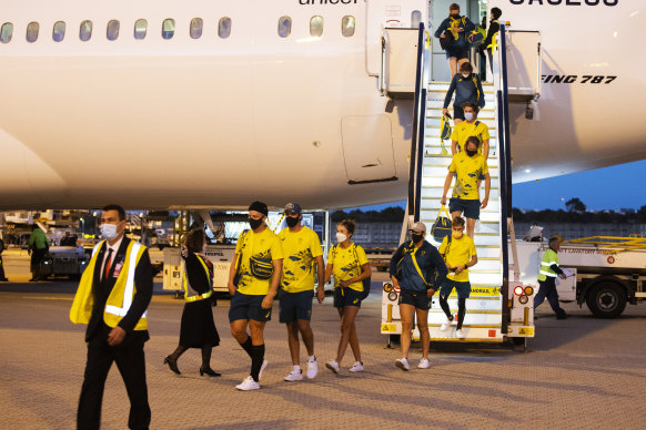 Australian Olympians exit their plane at Sydney International Airport, after returning from the Tokyo Olympics Games on Sunday.