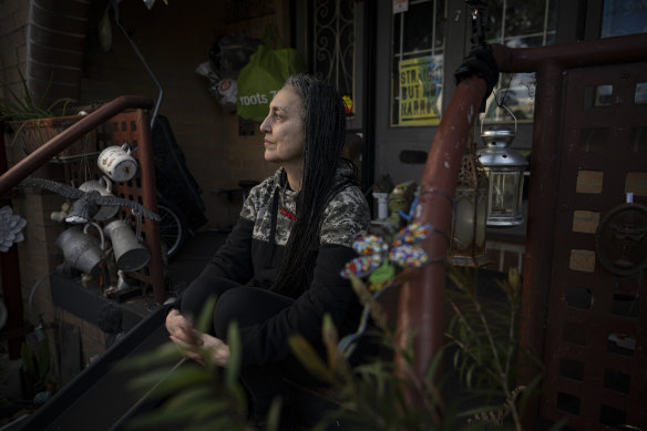 Carolyn Ienna, photographed in their Glebe apartment in 2022, told the City of Sydney they opposed the breaking up of a “three decades-long community” they had developed.