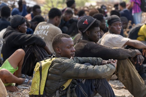 Migrants are detained by Moroccan security forces after attempting to cross the border.