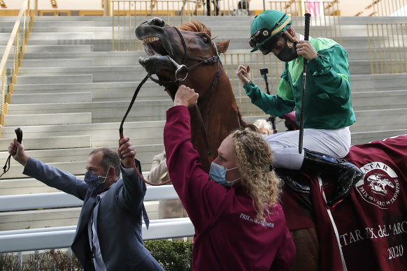 Jockey Cristian Demuro riding Sottsass celebrates after winning the Qatar Arc de Triomphe, outside Paris. 