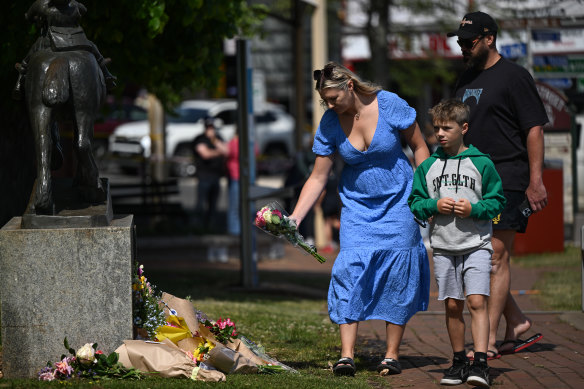 People lay flowers at a makeshift memorial in Daylesford.