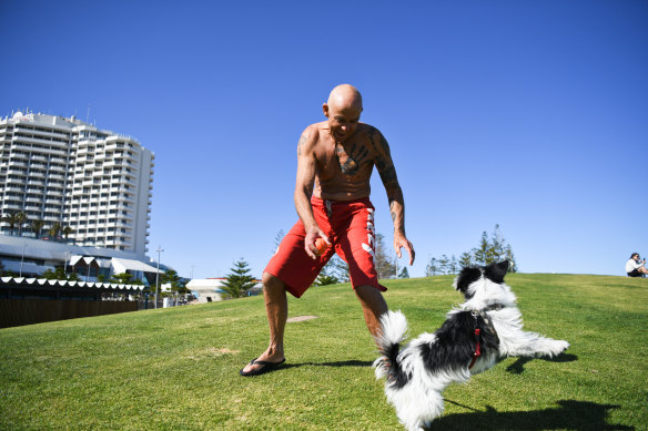 Greg Starke plays with a dog in Scarborough. 