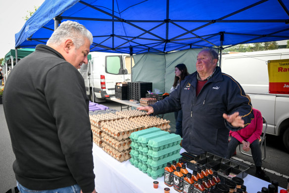Bill Duff the “egg man” with longtime customer Peter Stathopoulos