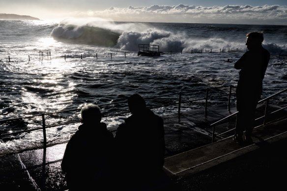 Spectators watch the monster waves roll in at  Dee Why early on Monday.