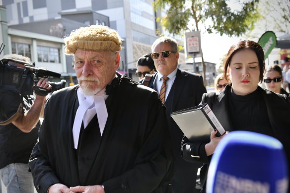 Button’s defence team arrive at Newcastle District Court on Monday.