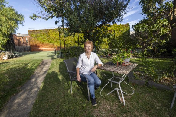 Elsternwick resident Lyn Campbell in her backyard, which VCAT found would be unreasonably affected by overlooking. 