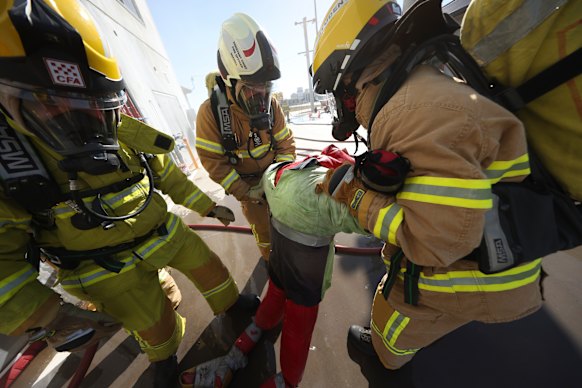 A dummy being dragged from the apartment building. 